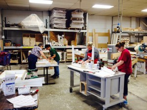 Volunteer administrators learning to construct coffee tables